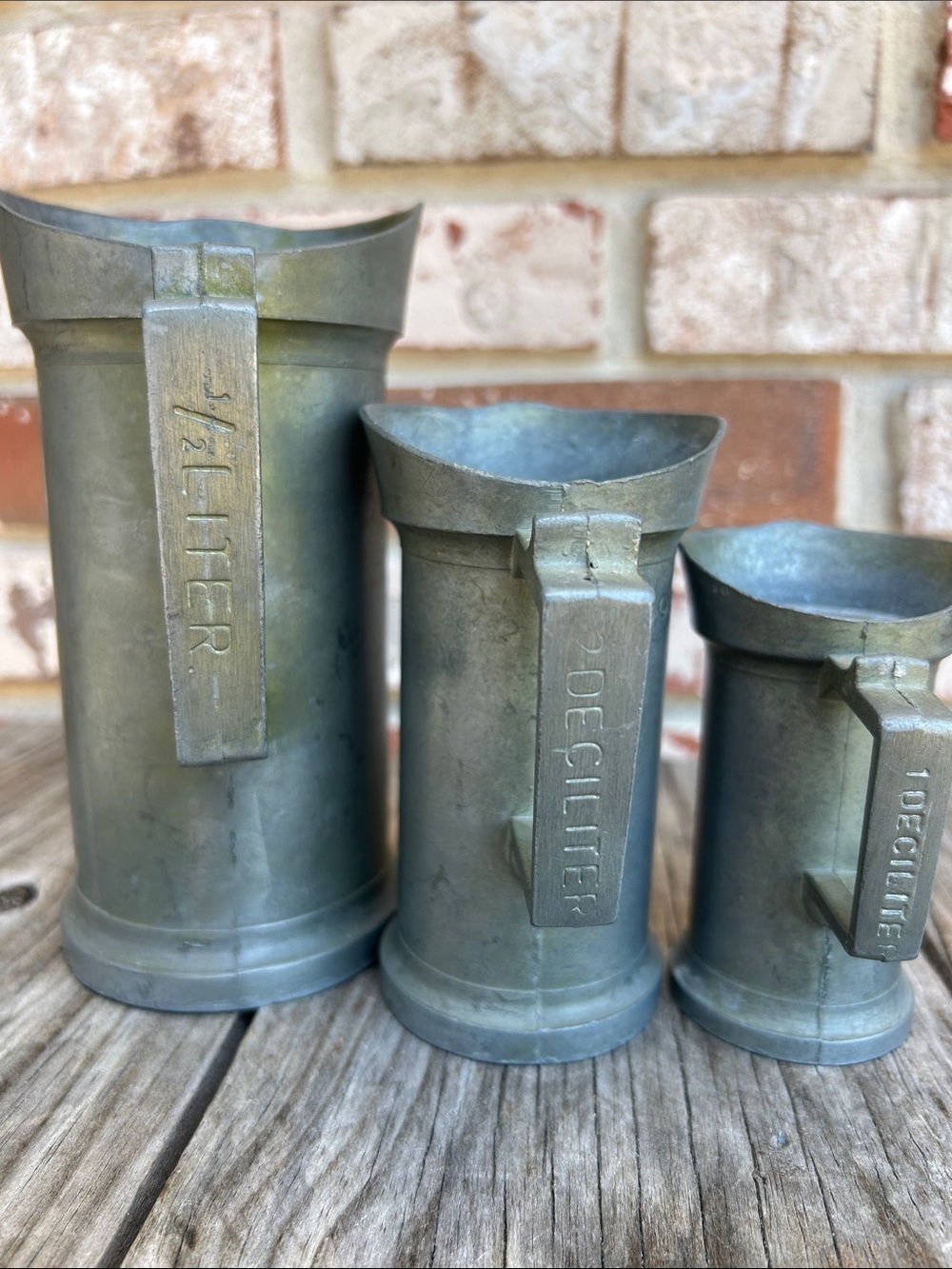 Three vintage pewter measuring jugs